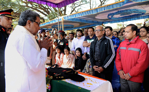 People gather near the mortal remains of Lt Col Niranjan Kumar at his home in Bengaluru on Monday. Kumar, a Lieutenant Colonel with the National Security Guard’s Bomb Disposal Squad, lost his life while defusing a grenade during the Pathankot terror attack on Sunday.